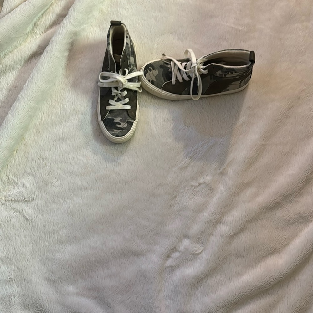 Camouflage high top tennis shoes.